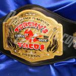 Torchy's Taco custom championship title belt was given away in 2014 to the taco eating champion. This double layer thick heavy metal belt was seen around the world and was a huge success for Torchy's Tacos